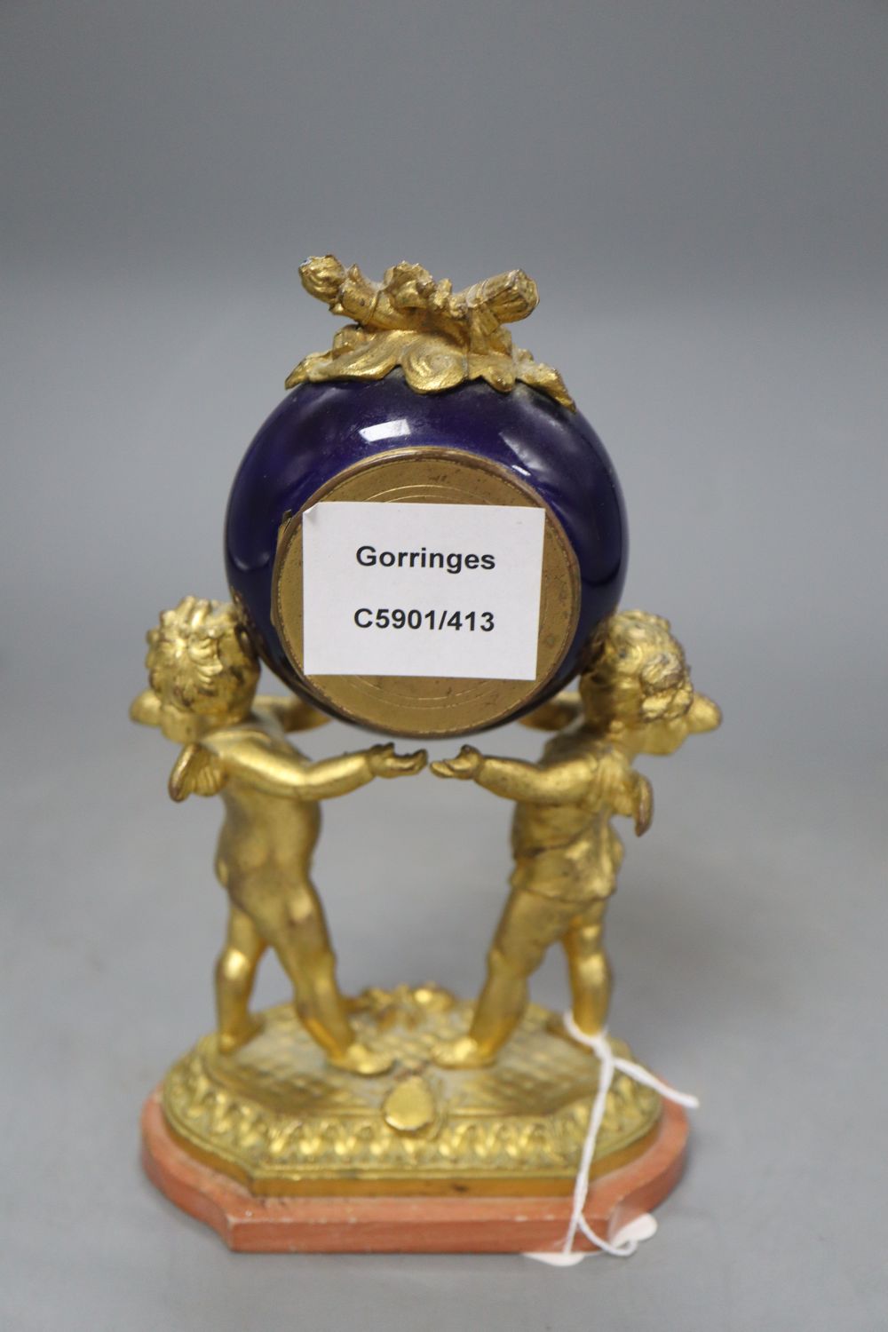 A French gilt metal and enamel cherub timepiece, height 18.5cm